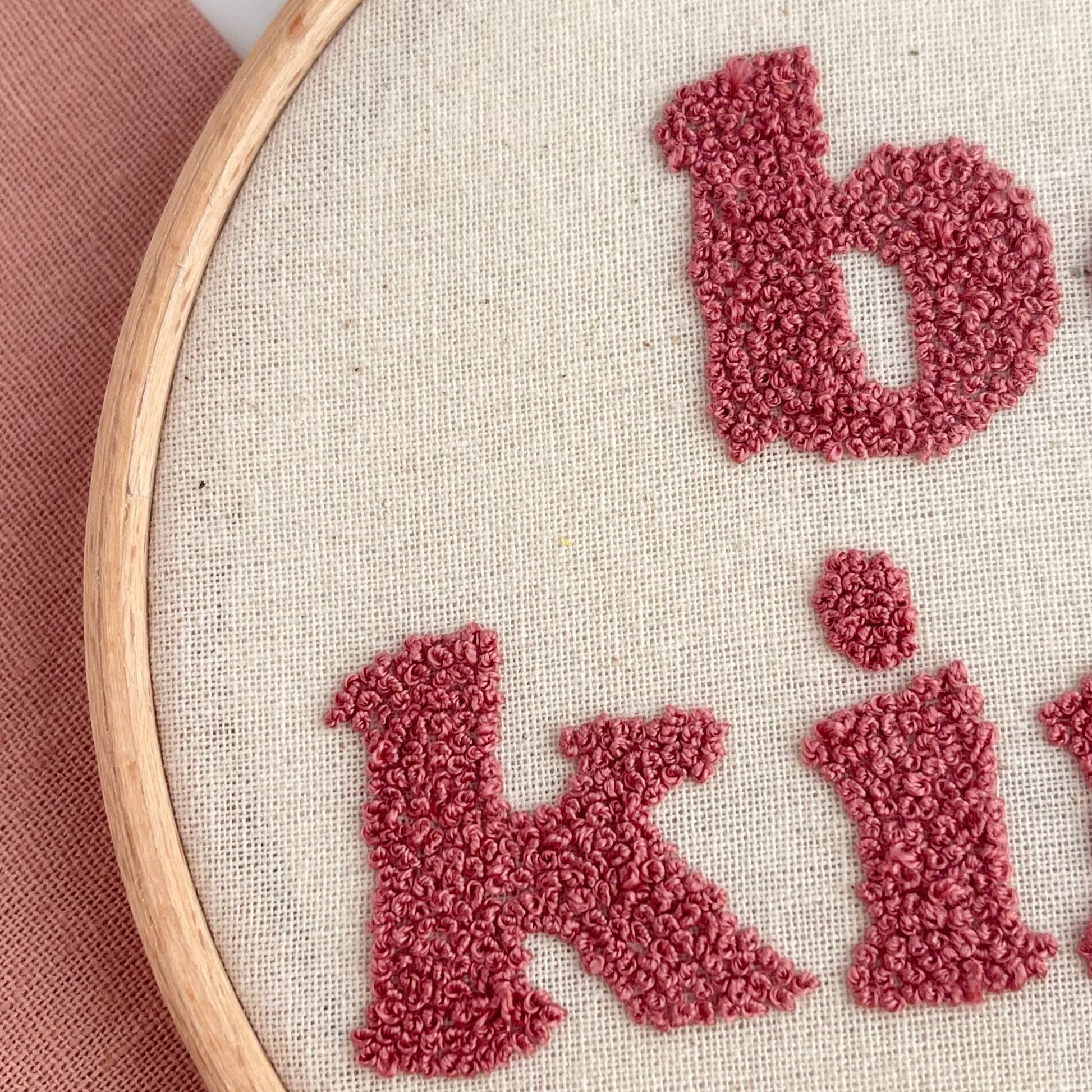 Close up of hand embroidered French Knots in typography letters
